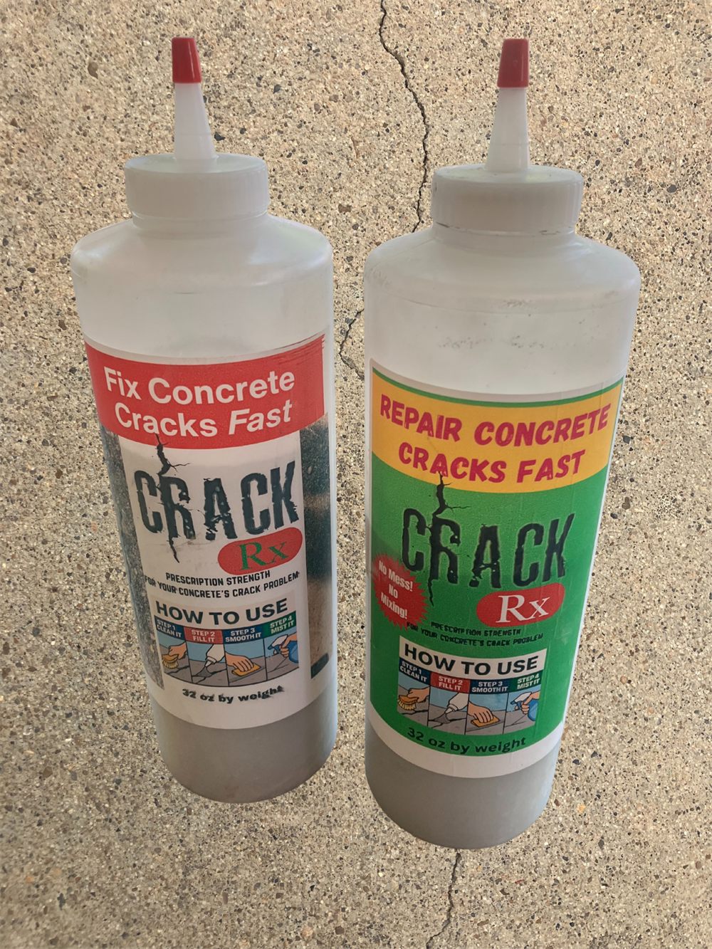 Two 32 oz CrackRx squeeze bottles standing on a concrete driveway